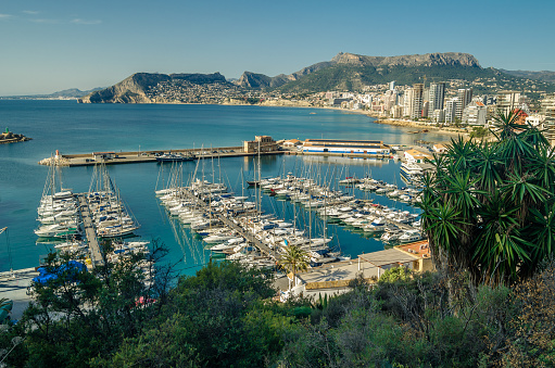Calpe, Spain - January 27, 2022: View of the fishing port of Calpe from the Peñon de Ifach Natural Park, Alicante province, Valencian Community, Spain