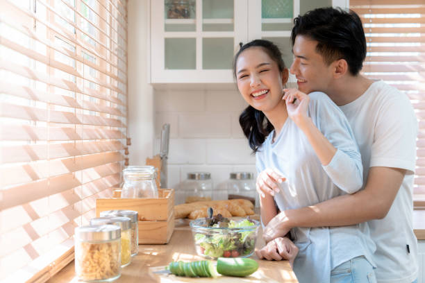 istock Happy Asian couple having fun in kitchen while preparing food. 1481065051