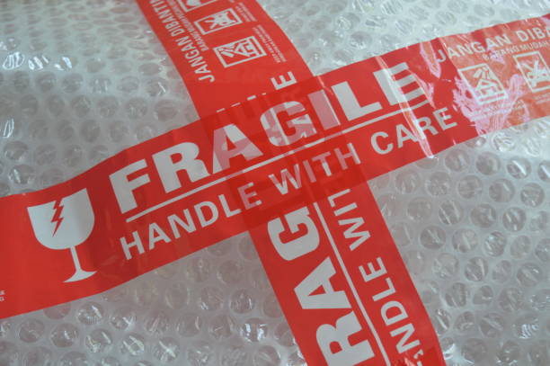 istock selective focus, packing goods in white bubble pacik and fragile tape 1481065256
