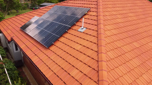 Aerial view of solar electricity panels on a house roof