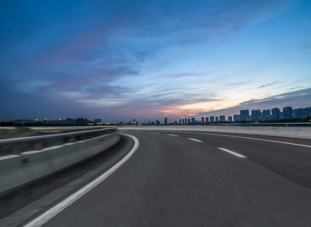 istock Asphalt road and the beautiful urban skyline at sunset 1481068331