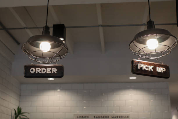 istock Wood Pick Up Here sign on counter bar with ceiling light casual take out dining restaurant or coffee shop 1481069682