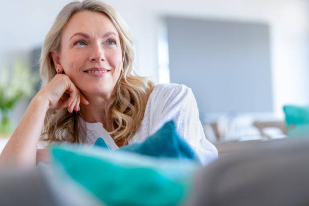 Mature woman relaxing on the sofa. stock photo