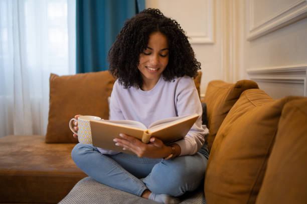 istock Woman relaxing and reading a book 1481070462
