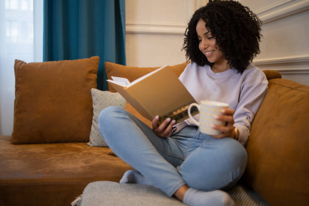 istock Woman relaxing and reading a book 1481070463