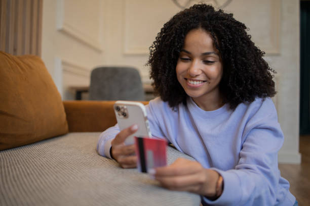 istock Cheerful  woman doing online shopping 1481070597