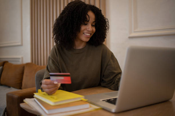 istock Cheerful  woman doing online shopping 1481070602
