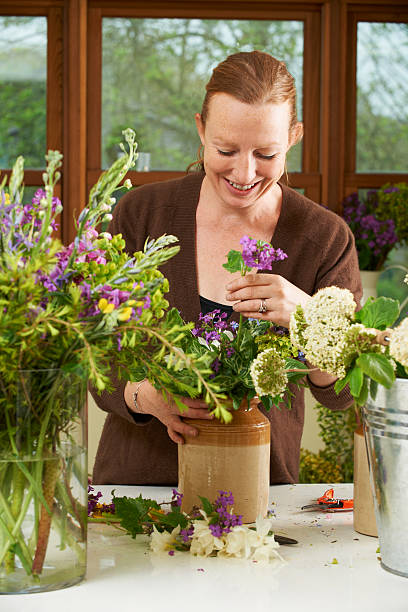 istock Florist Working On Arrangement In Shop 148107064