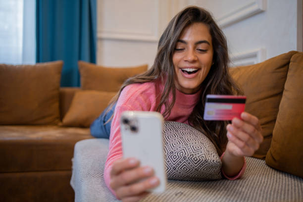 istock Cheerful  woman doing online shopping 1481070787