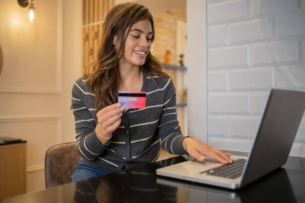 istock Cheerful  woman doing online shopping 1481070790