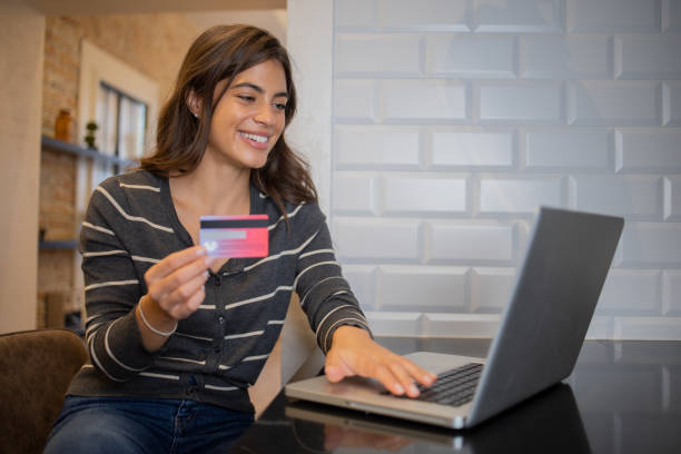 istock Cheerful  woman doing online shopping 1481070802