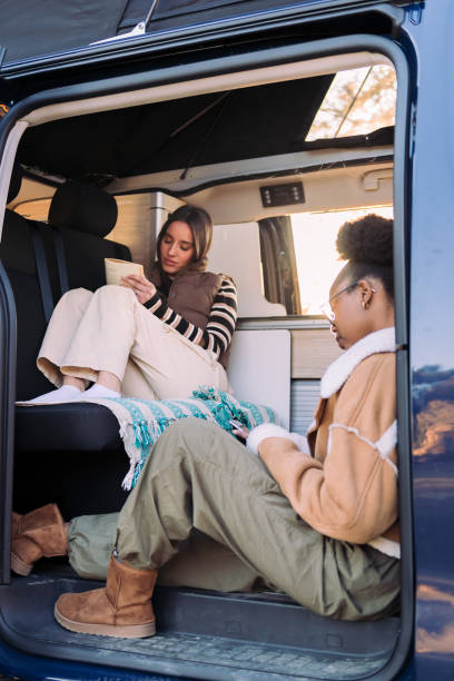 istock friends relaxing during a road trip in camper van 1481071170
