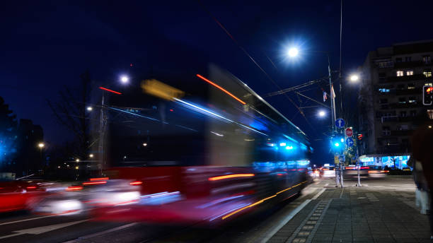 Bus rides on night city street