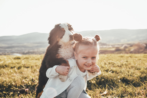 Girl playing with a small dog