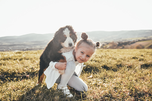 Girl playing with a small dog