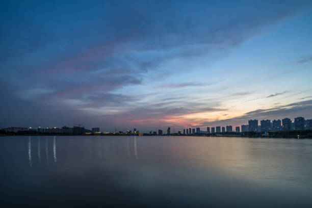 istock City Skyline By River Against Sky at twilight 1481074530