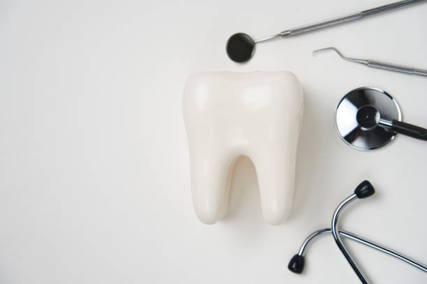 White healthy tooth, and dental tools for dentistry care. Dental background with copy space
