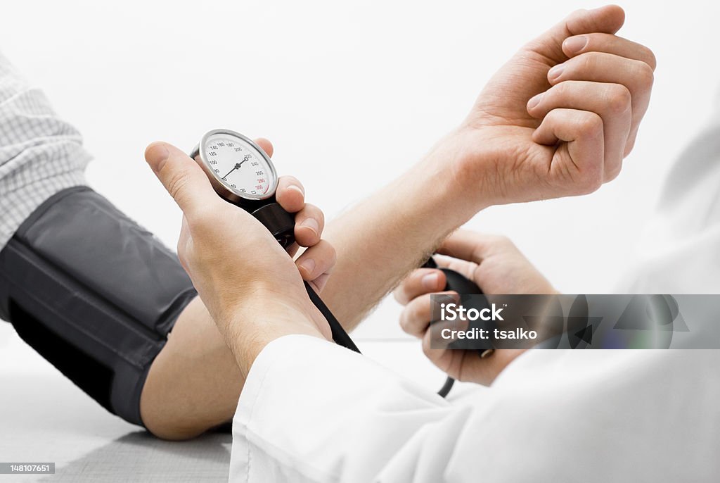 Blood pressure measuring studio shot Doctor measuring blood pressure - studio shot on white background Hypertensive Stock Photo
