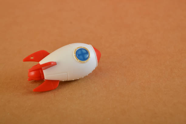 istock Toy rocket isolated on a brown background. Start up business concept. 1481080658