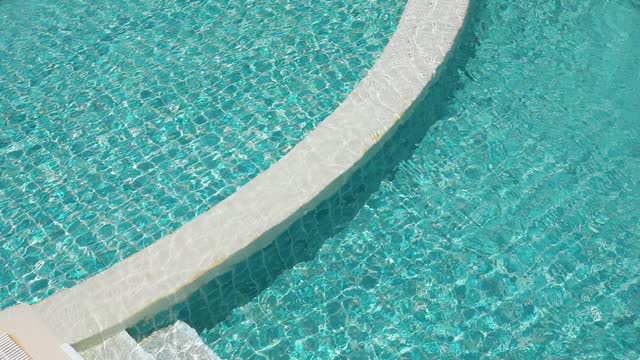 water wave slow motion on blue swimming pool, beautiful pool texture background