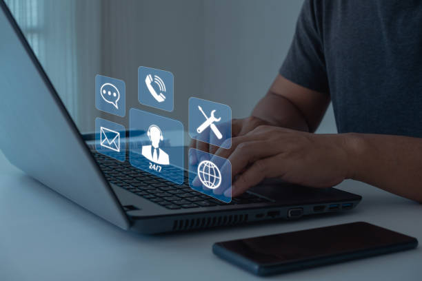 istock Technical Support Center Customer Service Internet Business Technology Concept. Person hand using laptop with VR screen support customer icon, IT support, call center and customer service help 24 hrs. 1481090381