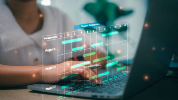 istock Business Project Management System. Project manager working on laptop and updating tasks and milestones progress planning with Gantt chart scheduling interface for the company on virtual screen. 1481095209
