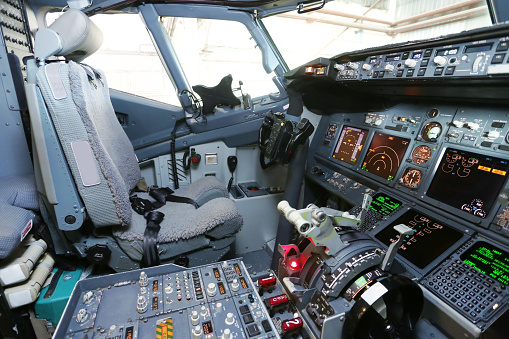 Two pilots in the cockpit of a modern passenger jet aircraft.