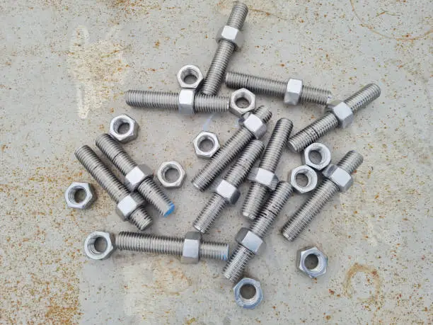 Photo of threaded bolts without heads or Stud bolts and stainless steel nuts