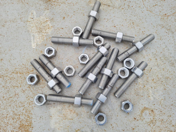 threaded bolts without heads or stud bolts and stainless steel nuts - bolt machine part screw threaded imagens e fotografias de stock