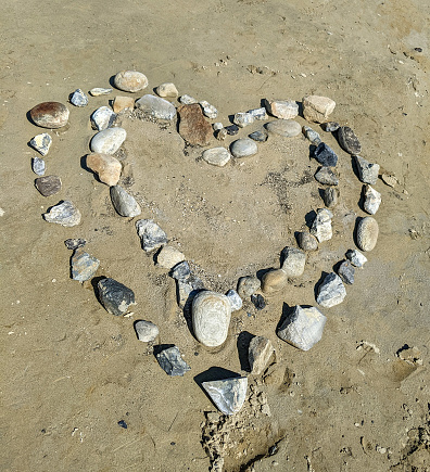 Hearts made out of rocks on the beach