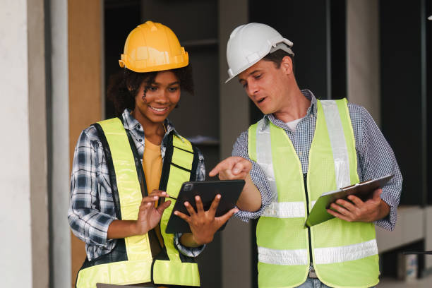 istock Engineer and Foreman builder team at construction site. American African foreman construction standing at construction site 1481104903