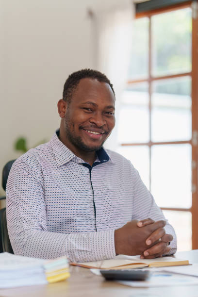 istock Smiling American African makes financial report and studies annual figures, analyzes profits. Accountant checks status of financial 1481106188