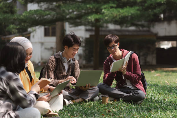 istock A multiethnic group of university students is studying together for an exam while sitting on the grass near the campus. 1481107427