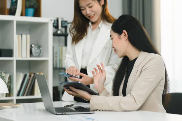 istock Two professional millennial Asian startup businesspeople are discussing evaluation data in a conference room, focusing on growth and pointing to a financial account chart,graph. 1481107510