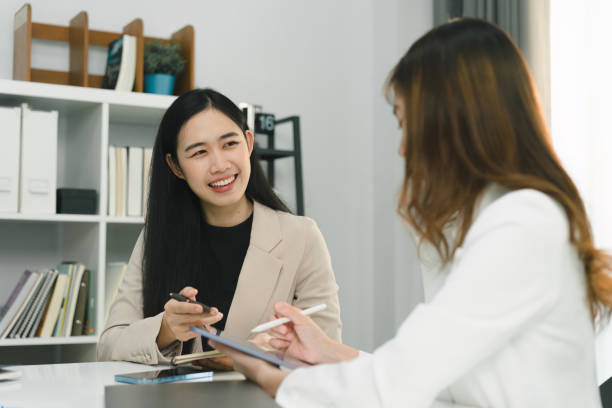istock Two professional millennial Asian startup businesspeople are discussing evaluation data in a conference room, focusing on growth and pointing to a financial account chart,graph. 1481107520