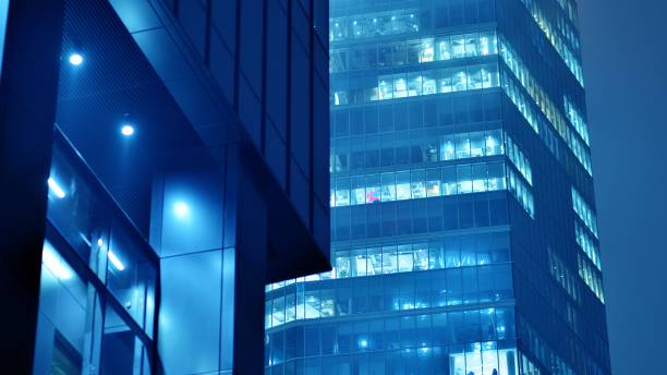 istock Pattern of office buildings windows illuminated at night. 1481109424