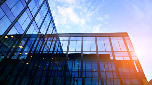 istock Glass modern building with blue sky background. Low angle view and architecture details. 1481109534
