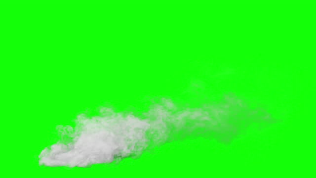 White smoke rises up from the ground. White steam or smoke rising up and slowly dissolving