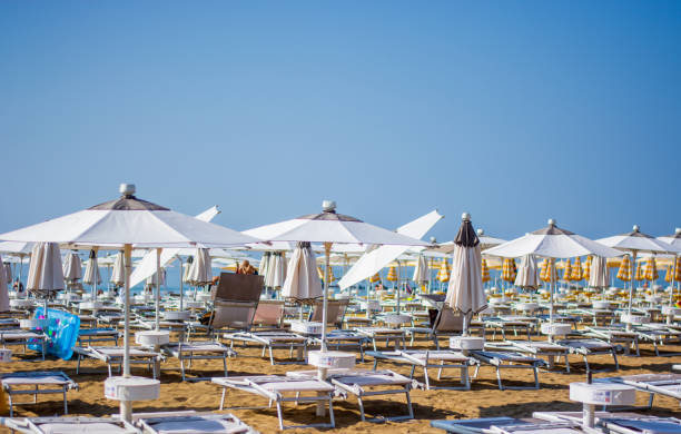 the umbrellas open for the beginning of the summer season - venice italy veneto architecture blue imagens e fotografias de stock