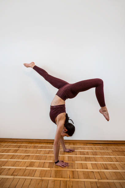 istock Young fit sport woman doing training body muscles working at flexibility at home 1481111886
