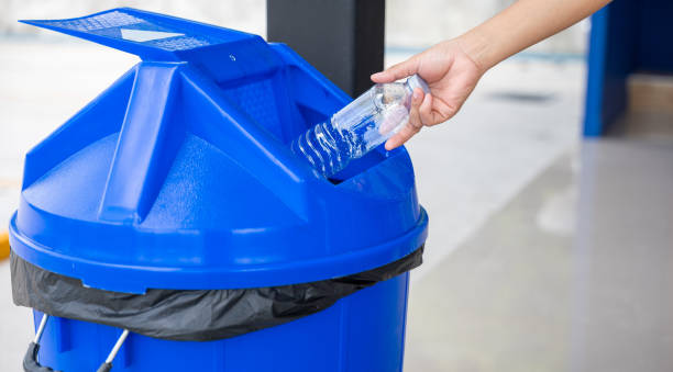 istock Close up woman hand throwing empty plastic water bottle into recycling bin 1481112997