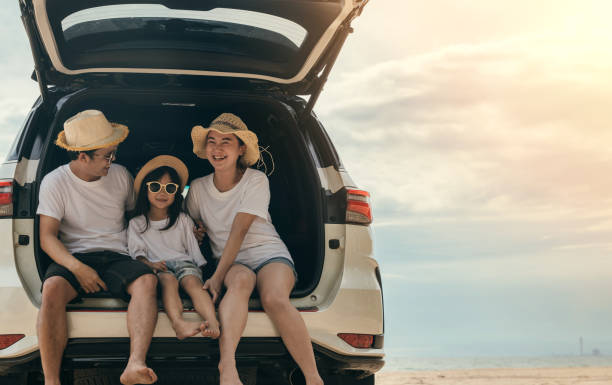 istock People enjoying road trip sitting down on back their car 1481113078