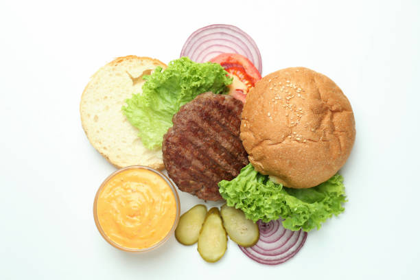 Fresh tasty burger with tomato, beef, french fries and red sauce on dark background. Restaurant style fast-food. Unhealthy food. American cuisine. Copy space stock photo