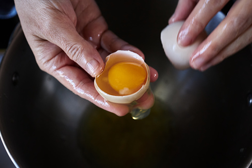 separating egg yolk with hand