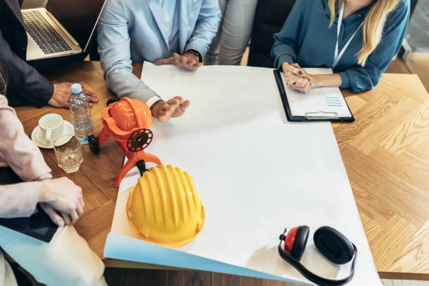 istock Architects, designers and engineers working on project together in boardroom. 1481118023