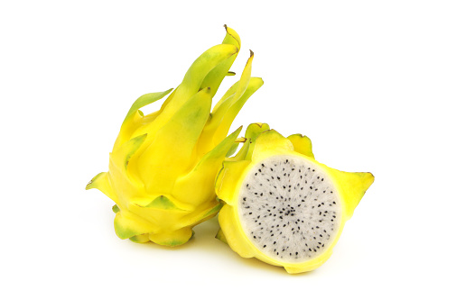 Yellow dragon fruits whole and halved  isolated on white background