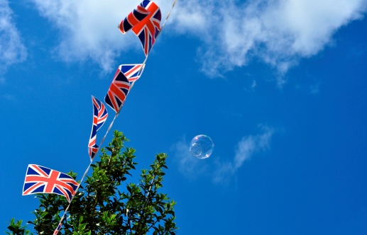 Bubbles float past some flapping Union Flags apart of the Diamond Jubilee street party celebrations.