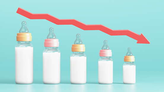 Fertility decline concept. Depopulation, demographic crisis. Baby bottles in the form of graph and down arrow. 3d illustration.