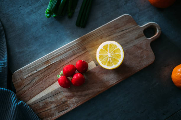 Fresh radish and lemon on a wooden board