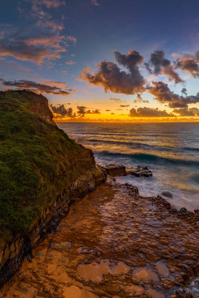 istock Sunrise and clouds over the ocean and rock platform 1481122333